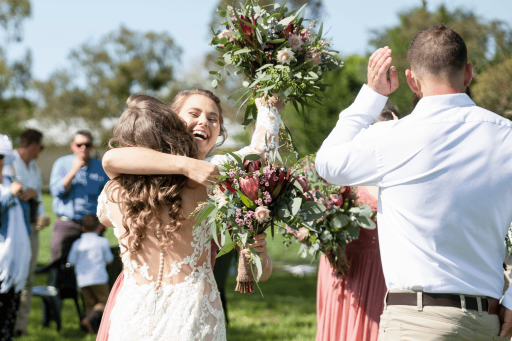 bride hugging bride after wedding ceremony in Country NSW