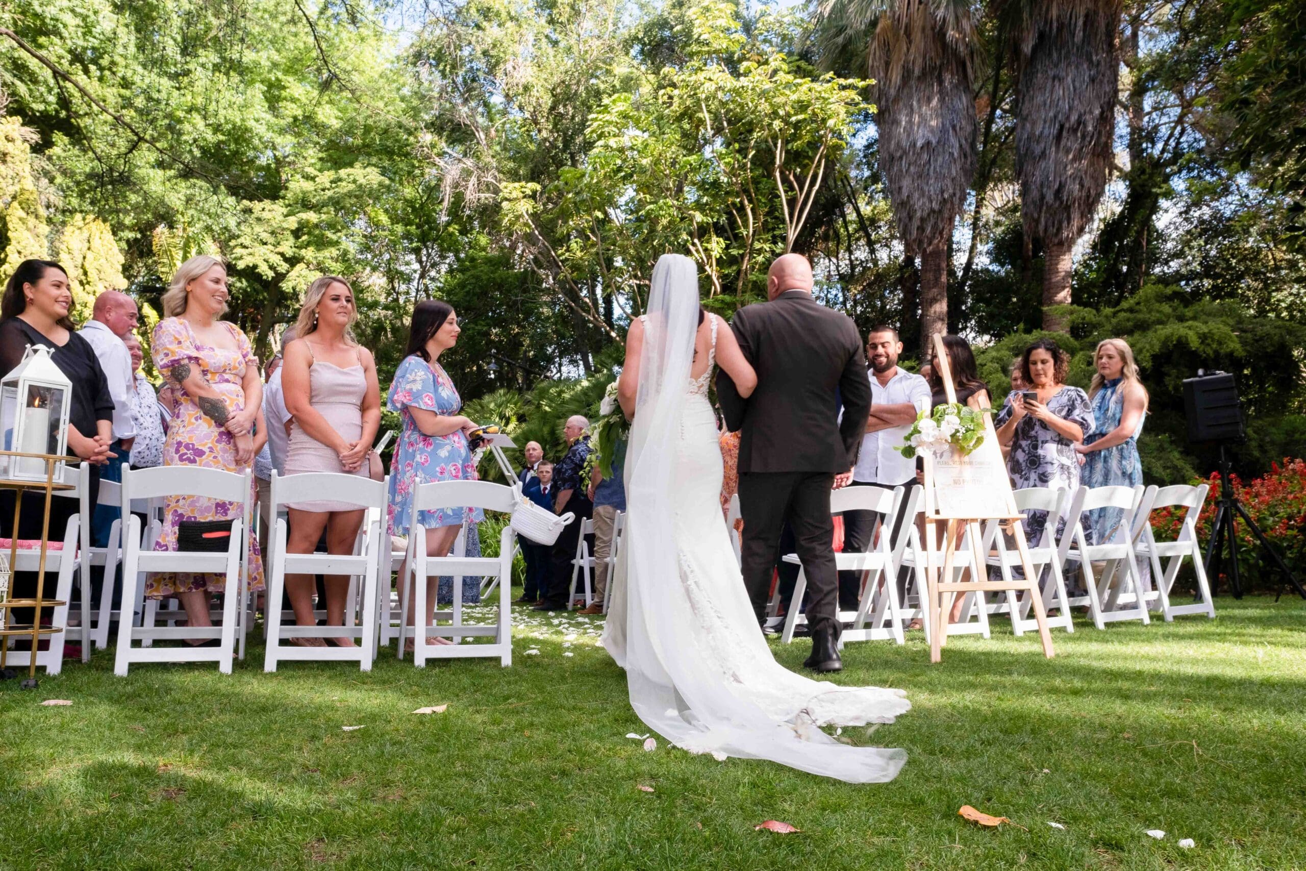 bride walking down aisle with father during weekday wedding