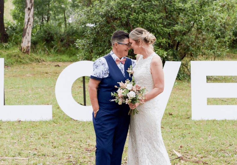 bride and bride posing for wedding photographer after melbourne wedding