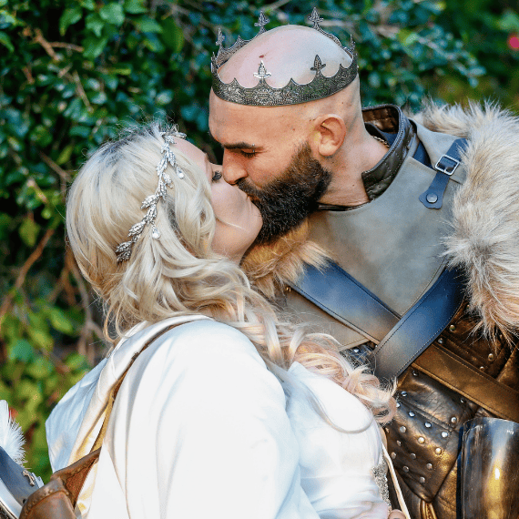close up of bride and groom kissing at viking themed wedding